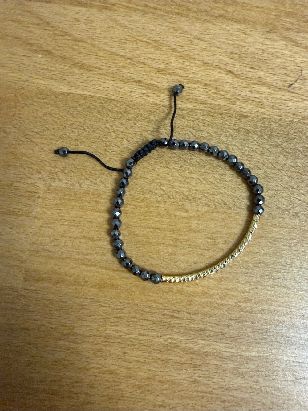 Gray crystal bead with gold tone hammered accent string adjustable bracelet
